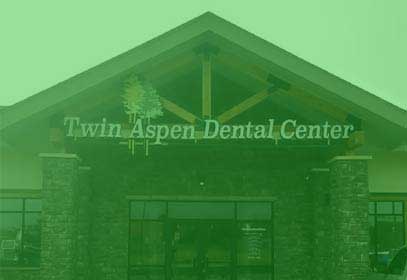 A full shot of twin aspen dental center store signage.